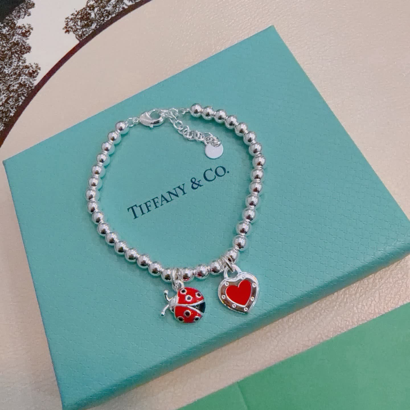Tiffany & Co. Silver Bead Bracelet with Ladybug and Heart Charms